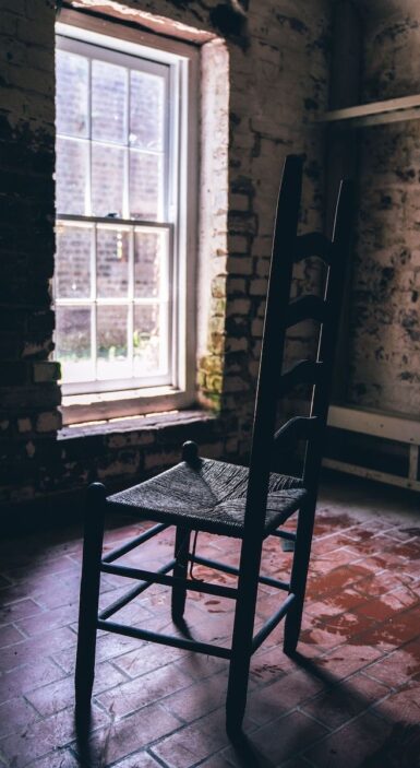 black wooden chair near window